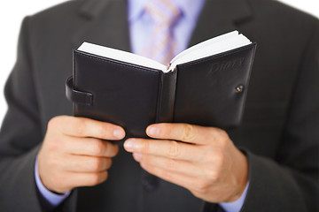 Image showing Businessman reading notebook with inscription - Diary