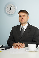 Image showing Young chief sitting on workplace