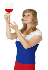 Image showing Woman - taster checks color and opacity of wine