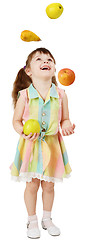 Image showing Little funny girl juggles fruit