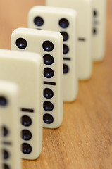 Image showing Dominoes on wooden surface abreast