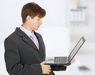 Image showing Engineer works with laptop on hands