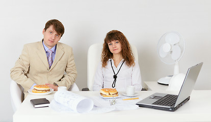 Image showing Businessmen prepare for a dinner sitting at a table