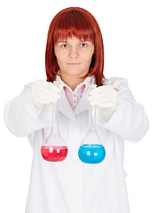 Image showing Woman - scientist holding flasks with colored liquids