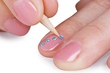 Image showing Close up - gluing paste on nails