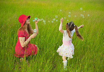 Image showing Mum and daughter starting up soap bubbles