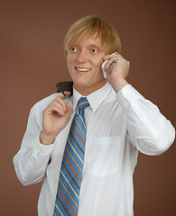 Image showing Young man talks by mobile phone