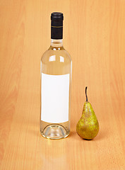 Image showing Bottle of pear wine on wooden background