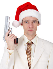 Image showing Young man in Christmas hat with gun