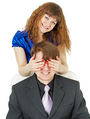 Image showing Playful woman covered eyes of man