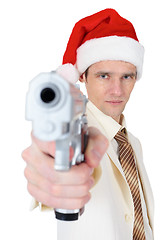 Image showing Guy in Christmas hat aiming a gun