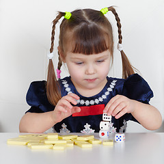 Image showing Child playing with small toys at table