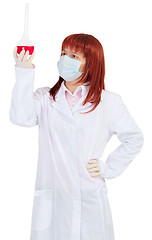 Image showing Woman - scientist analyzes color of solution in flask