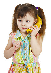 Image showing Girl tries to speak by means of banana