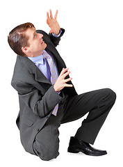 Image showing Young man scared and sat on white background