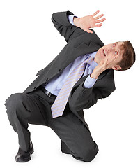 Image showing Frightened businessman sitting on white background