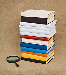 Image showing Pile of books and magnifying glass - Educational still life