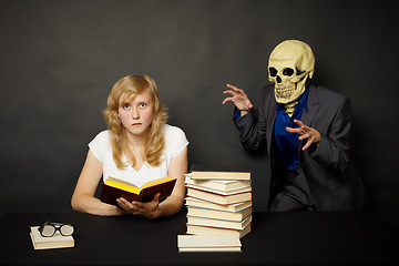 Image showing Woman reading a terrible book in dark