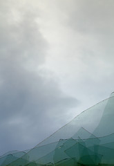 Image showing Cloudy sky through broken window