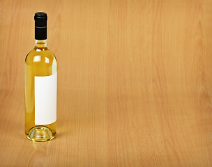 Image showing Bottle of white wine on wooden table