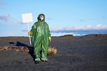 Image showing Man in overalls holding a white plate