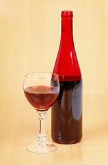 Image showing Bottle of red wine and full glass