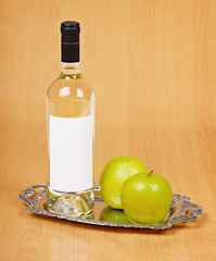 Image showing Apple wine in closed bottle on tray