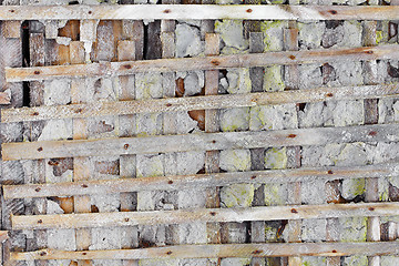 Image showing Ruined wall with wooden lattice - background