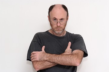 Image showing Unshaved disheveled man in spectacles frowning