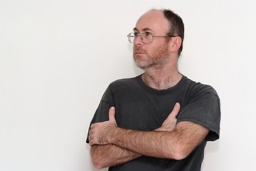 Image showing Unshaved disheveled man in spectacles frowning 