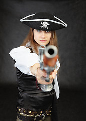 Image showing Woman pirate aims in us from an ancient pistol