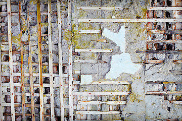 Image showing Wooden planks in damaged old concrete wall