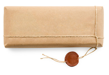 Image showing Postal parcel in coarse paper on white background