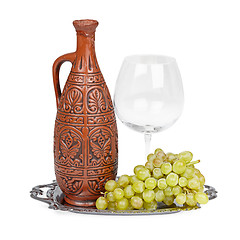 Image showing Still life of ceramic bottle, grapes and glass