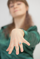 Image showing Girl brags of new ring with blue stone