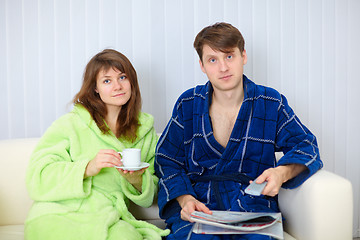 Image showing Young couple watching TV on sofa