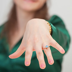 Image showing Woman shows new ring with blue gem