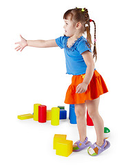 Image showing Little girl in dress with toys on white background