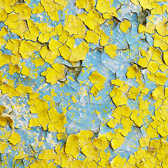 Image showing Yellow wall covered with scraps of paint