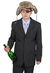 Image showing Funny man in fur hat with a bottle on a white background