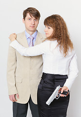 Image showing Young man and beautiful woman with gun in hand