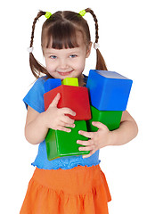 Image showing Little happy girl with toys in hands