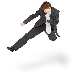 Image showing Fighting businessman kicked in jump, isolated on white backgroun