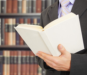 Image showing Man reads a book in library