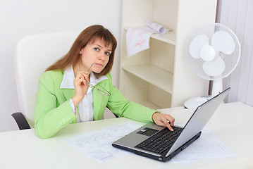 Image showing Funny girl working with laptop in office