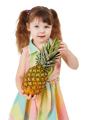 Image showing Child holding large ripe pineapple isolated on white