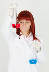 Image showing Woman chemist with colored flasks