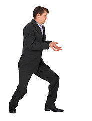 Image showing Young businessman pushing