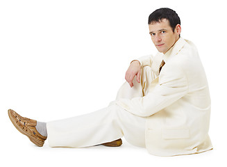 Image showing Man in light business suit siting on white