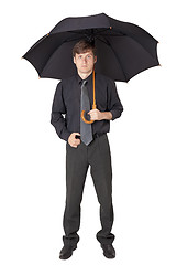 Image showing Serious man in black clothes with an umbrella